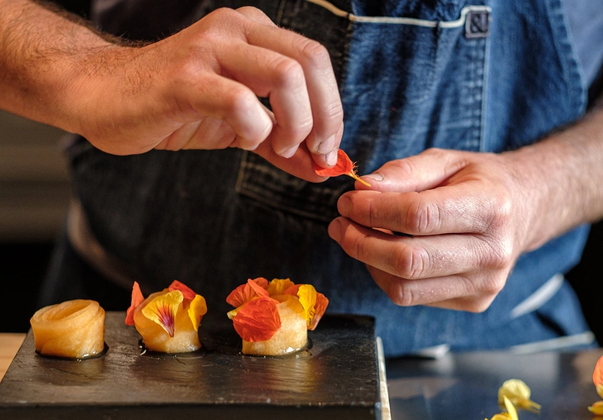 A close-up shot of chef Giulio Sturla's hands preparing food