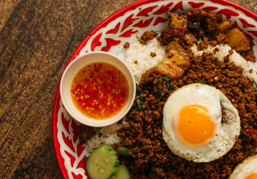 A dish of jumbo krapao at Kiin Thai Kitchen restaurant, with spicy pork mince on top of rice, sauce, cucumber and topped with fried eggs