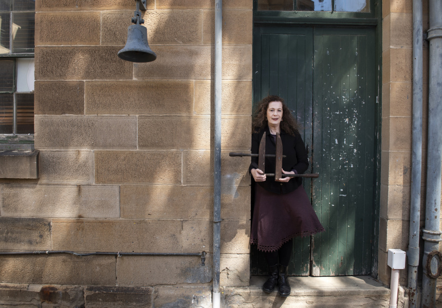 Deborah Beck, Archivist and Collections Manager, 2020, with Darlinghurst Gaol's prison bell
