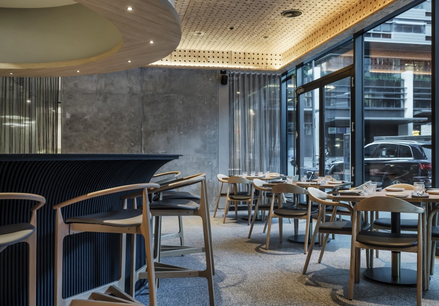 The interiors of Koi, featuring concrete walls and modern seating
