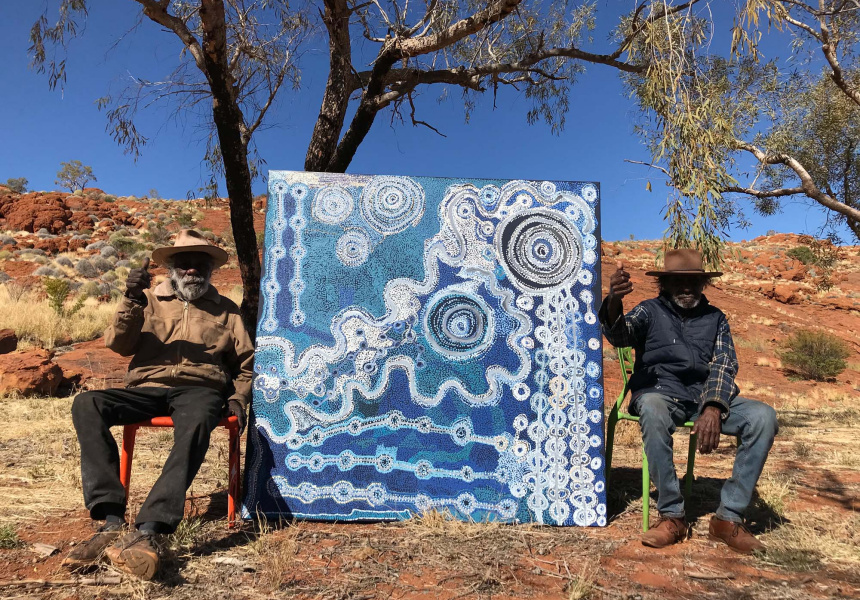 Taylor Wanyima Cooper and Witjiti George with their collaborative painting, 2021, Fregon, South Australia; Courtesy the artists and Kaltjiti Arts
