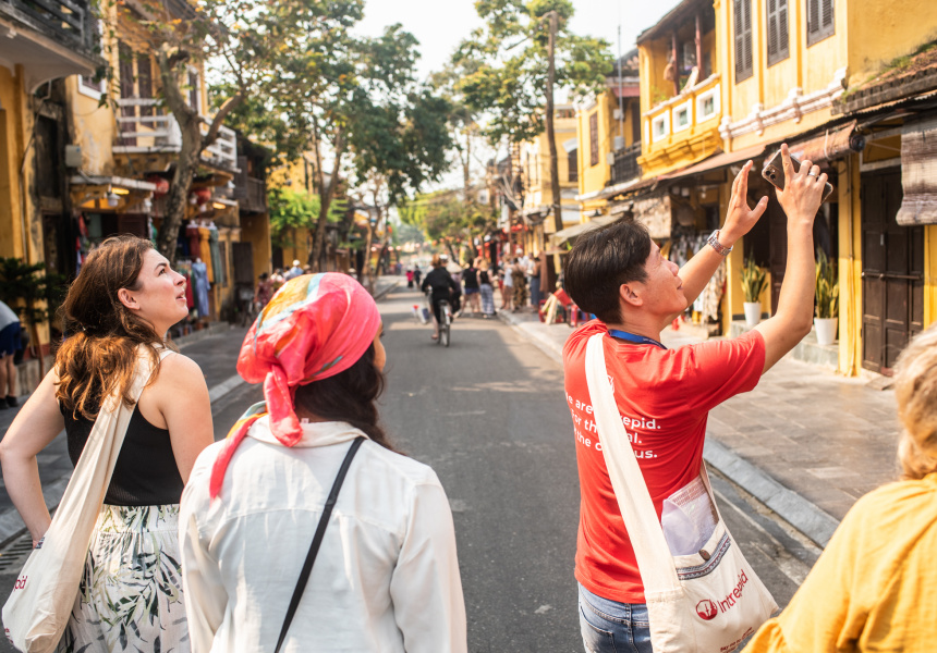 Father and two daughters attempting to cross a busy road Ho Chi