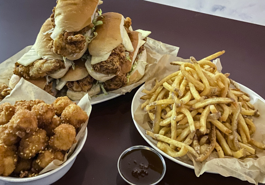 Bonza burger with popcorn honey shrimp, chips and sweet and sour sauce.
