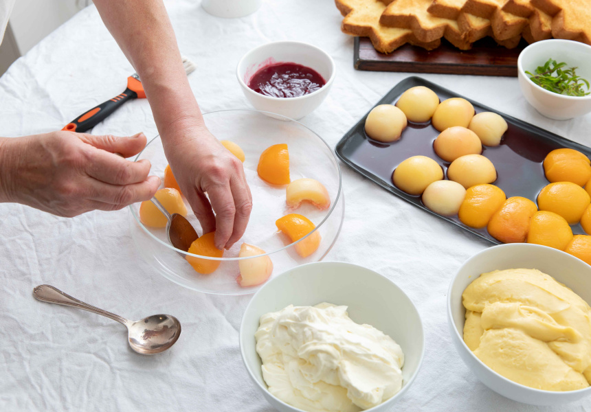 To assemble the trifle, place a ring of peaches, cut-side down, around the perimeter of large glass bowl or other presentation dish.
