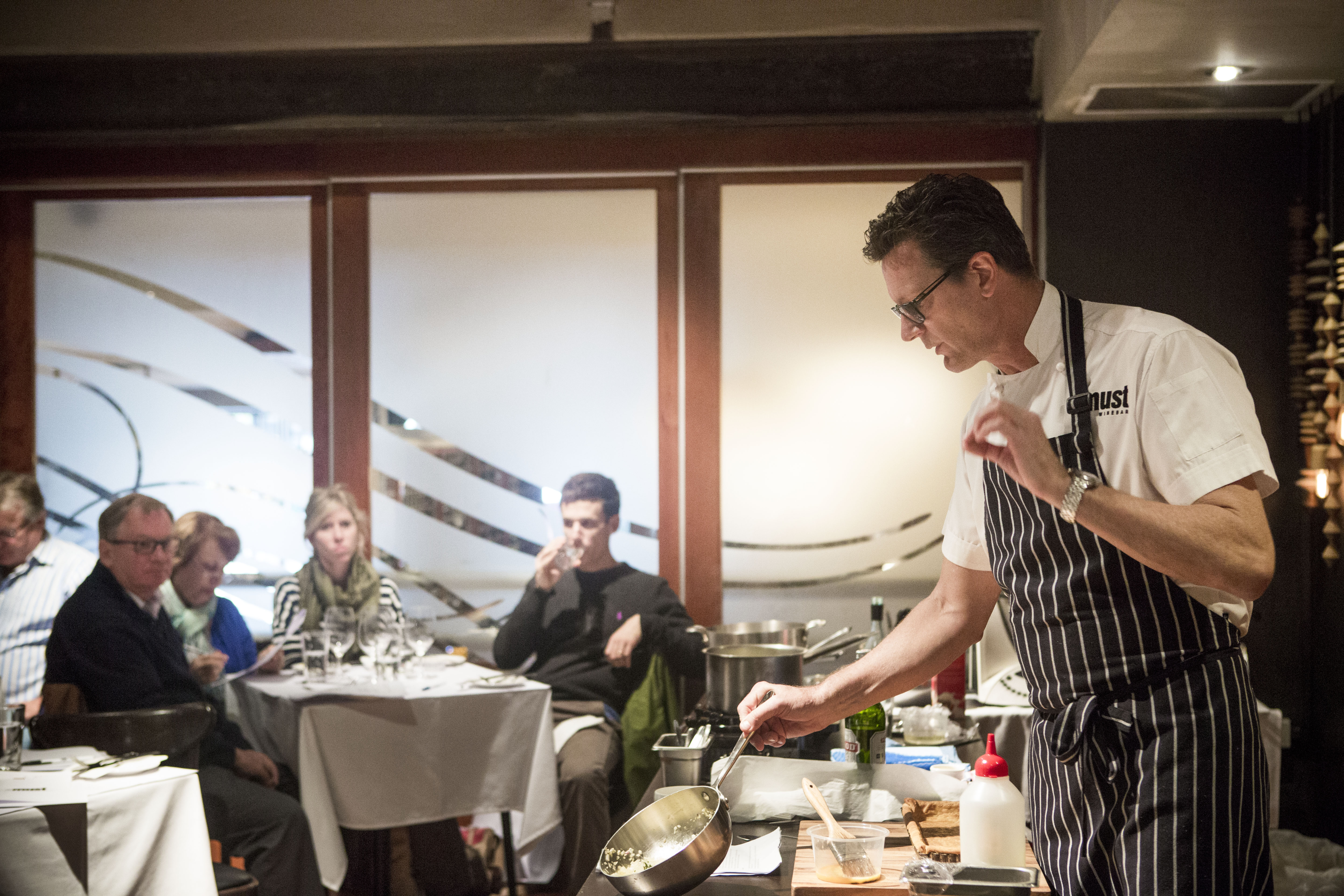 Executive chef Russell Blaikie leads a cooking class in the Must private dining room, 2015
