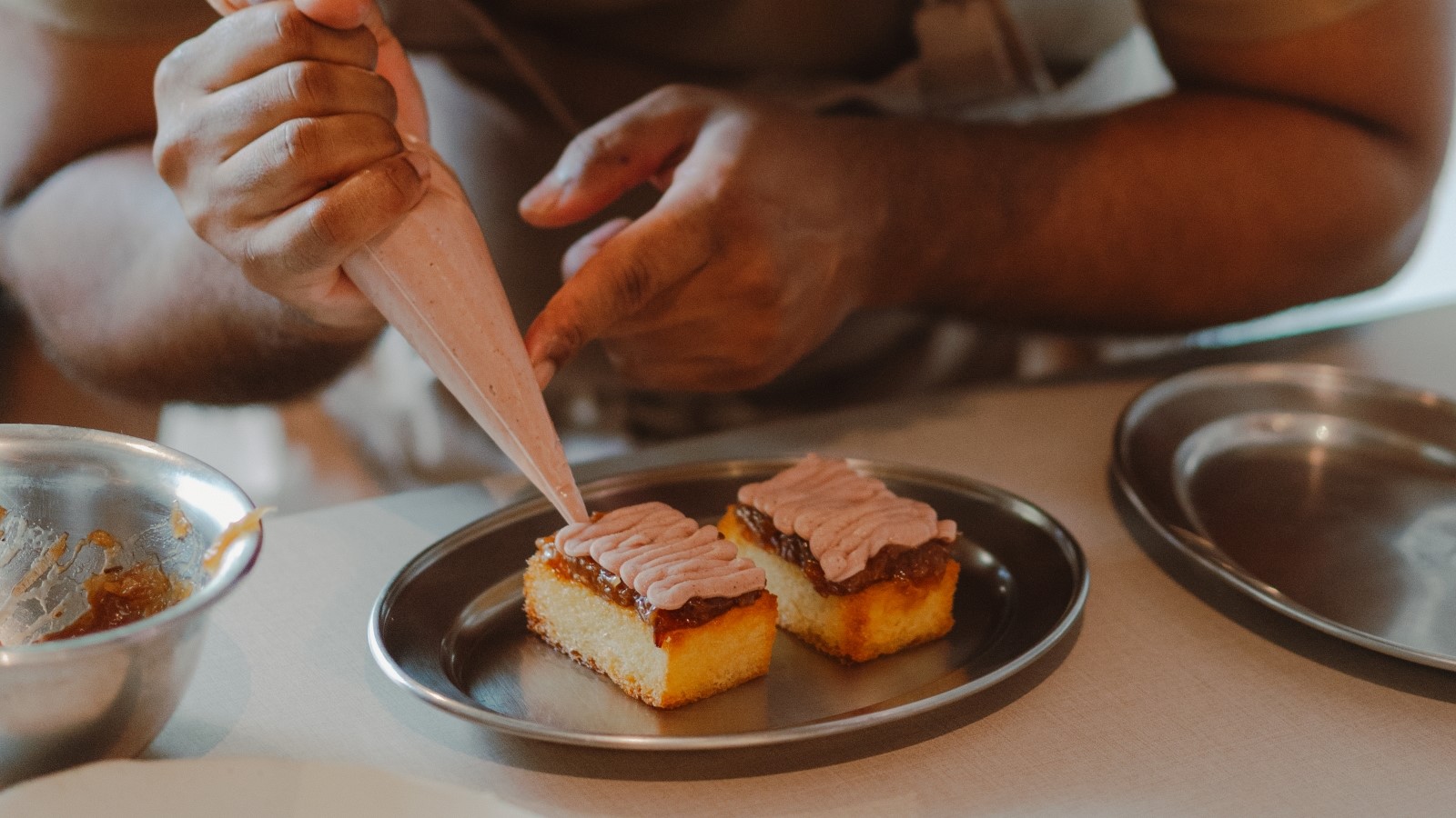 A chef pipes Vow’s cultured Japanese quail parfait onto toast at Wildcard in Singapore. Photo: courtesy of Vow