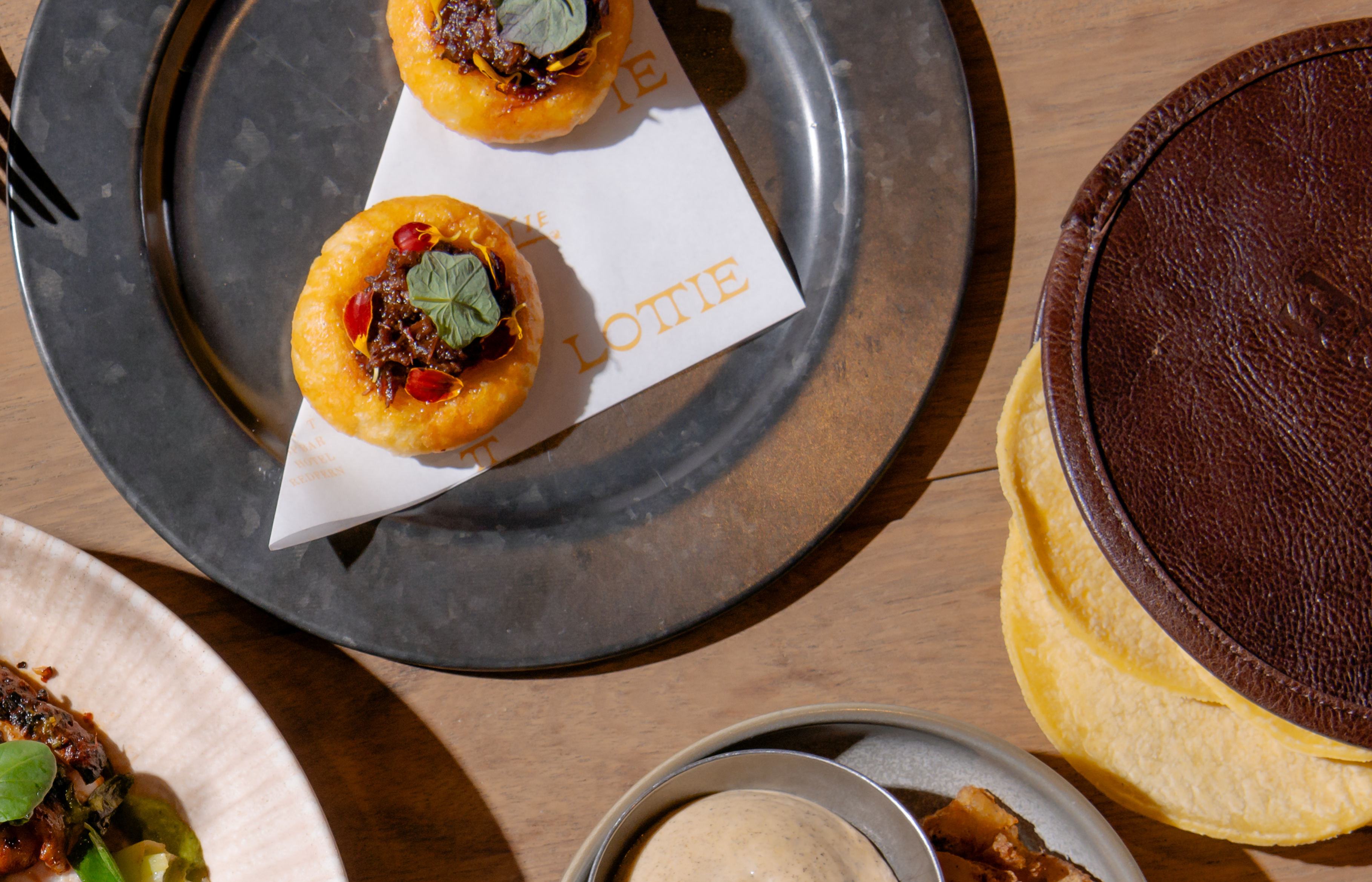 A close-up of a potato sope topped with kangaroo and nasturtium.